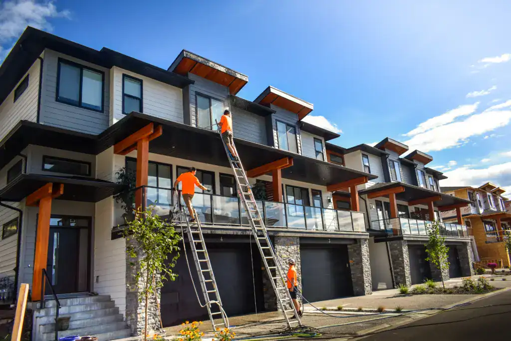 Live Next Level crew washing the exterior of Lake Country townhomes from ladders