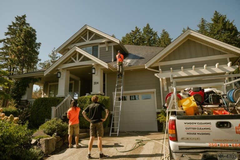 Live Next Level technician talking with a homeowner in the driveway after a roof treatment