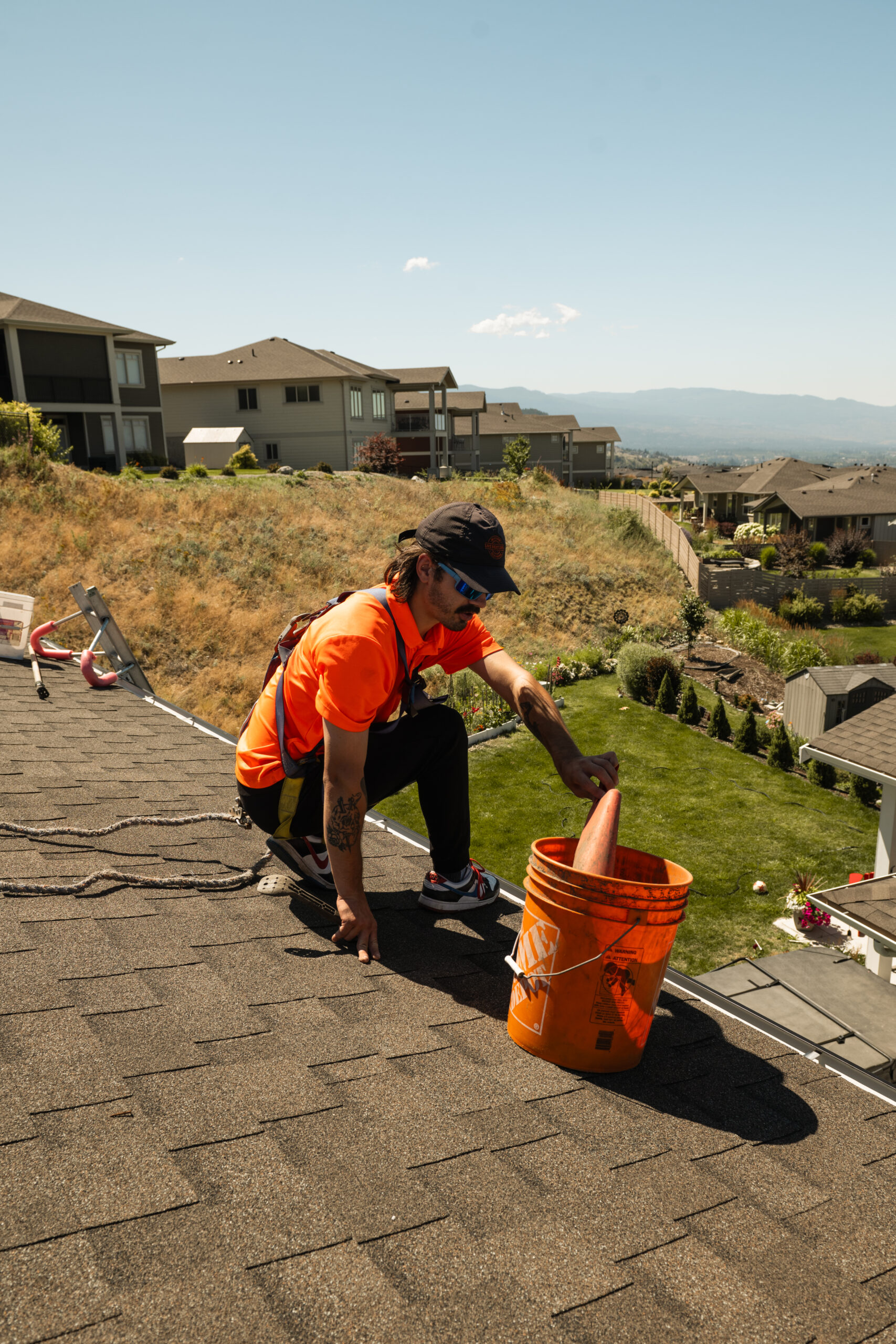 Property maintenance technician removing gutter debris during fall cleaning