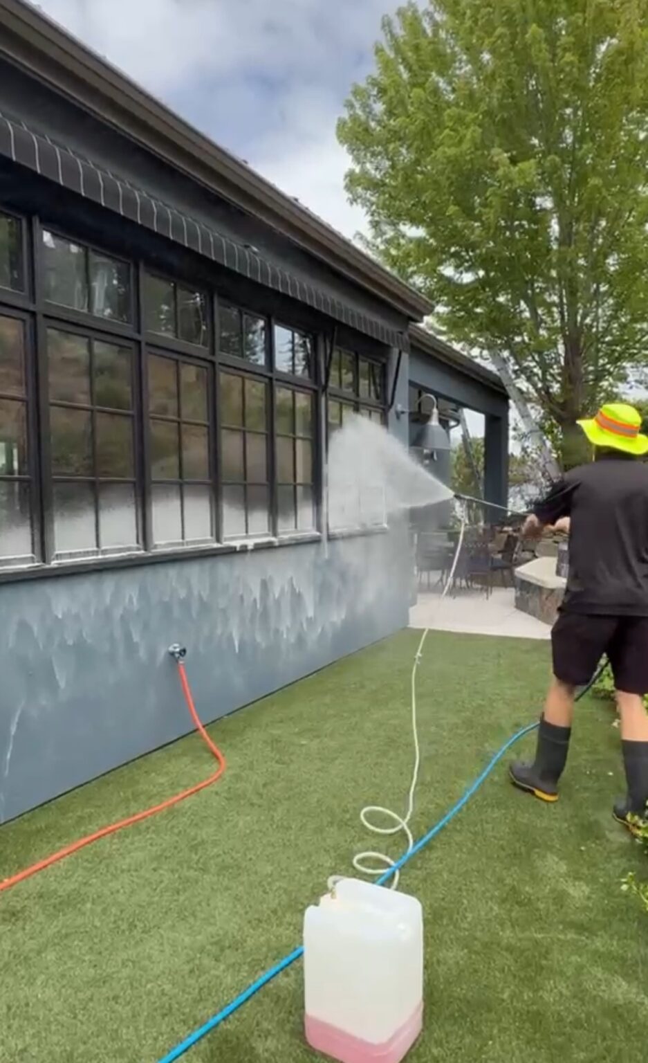 Soft wash solution applied at low pressure to the stucco and windows of a Kelowna home